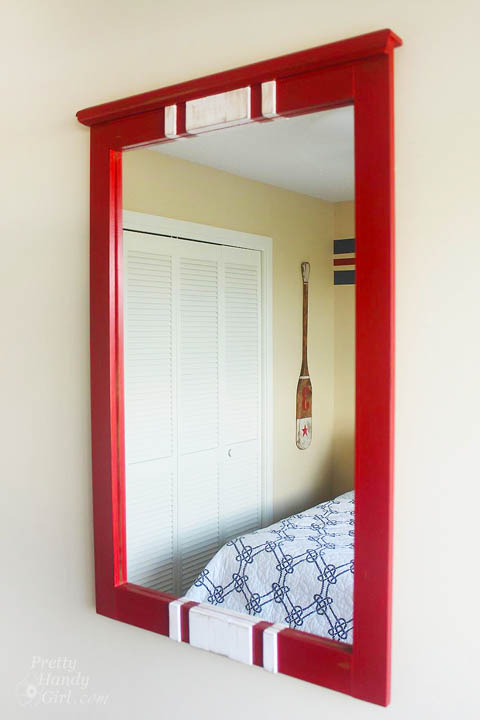 Some red milk paint, lattice and glue transform this $15 find into a charming racing stripe mirror perfect for a boys' room! | thrift store makeover | DIY mirror | mirror tutorial | #prettyhandygirl #DIY #tutorial