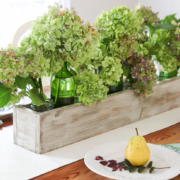Green and purple hydrangeas in rustic wood trough. Build Your own Rustic Trough Centerpiece tutorial.