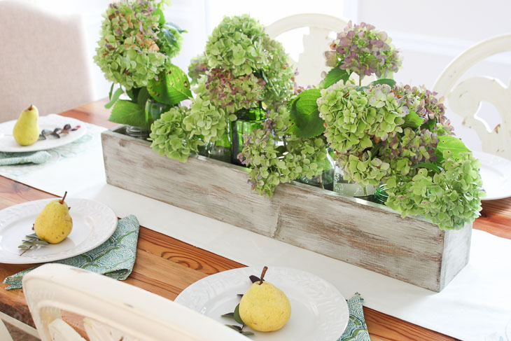 Green and purple hydrangeas in rustic wood trough. Build Your own Rustic Trough Centerpiece tutorial.