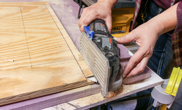 use Dremel Saw Max to cut groove in bottom of barn door