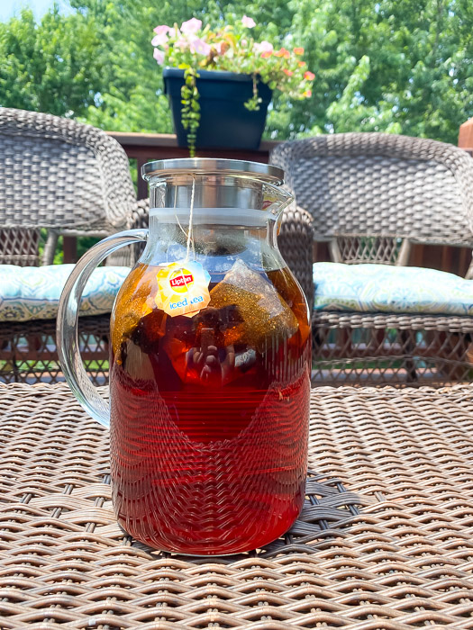 Sun tea brewing outside in a glass pitcher