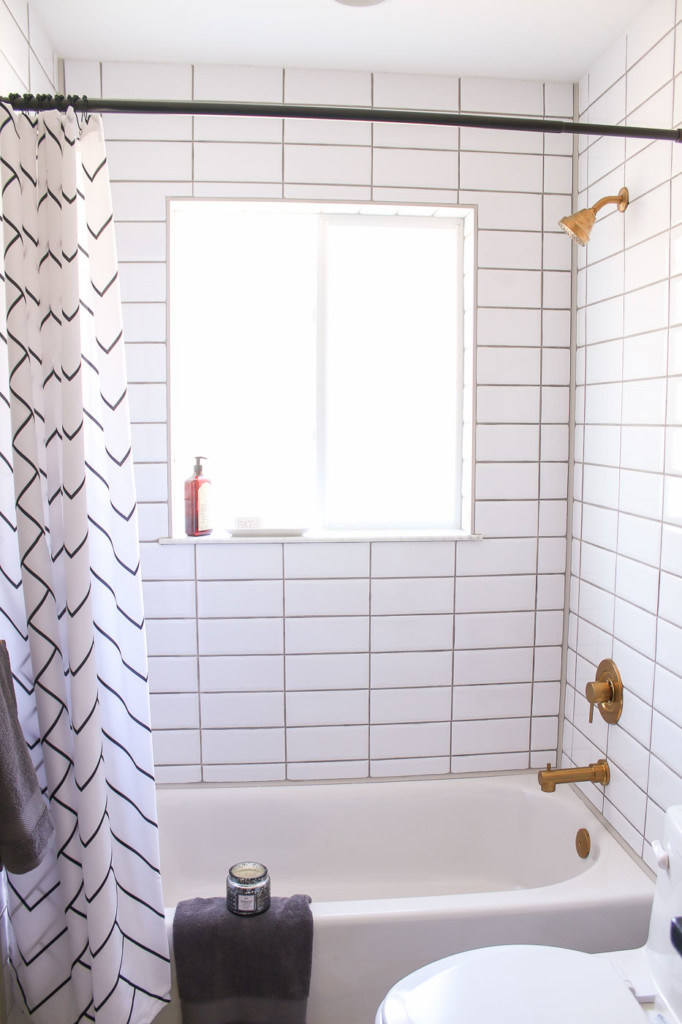 bright window in shower with white stacked tile around window
